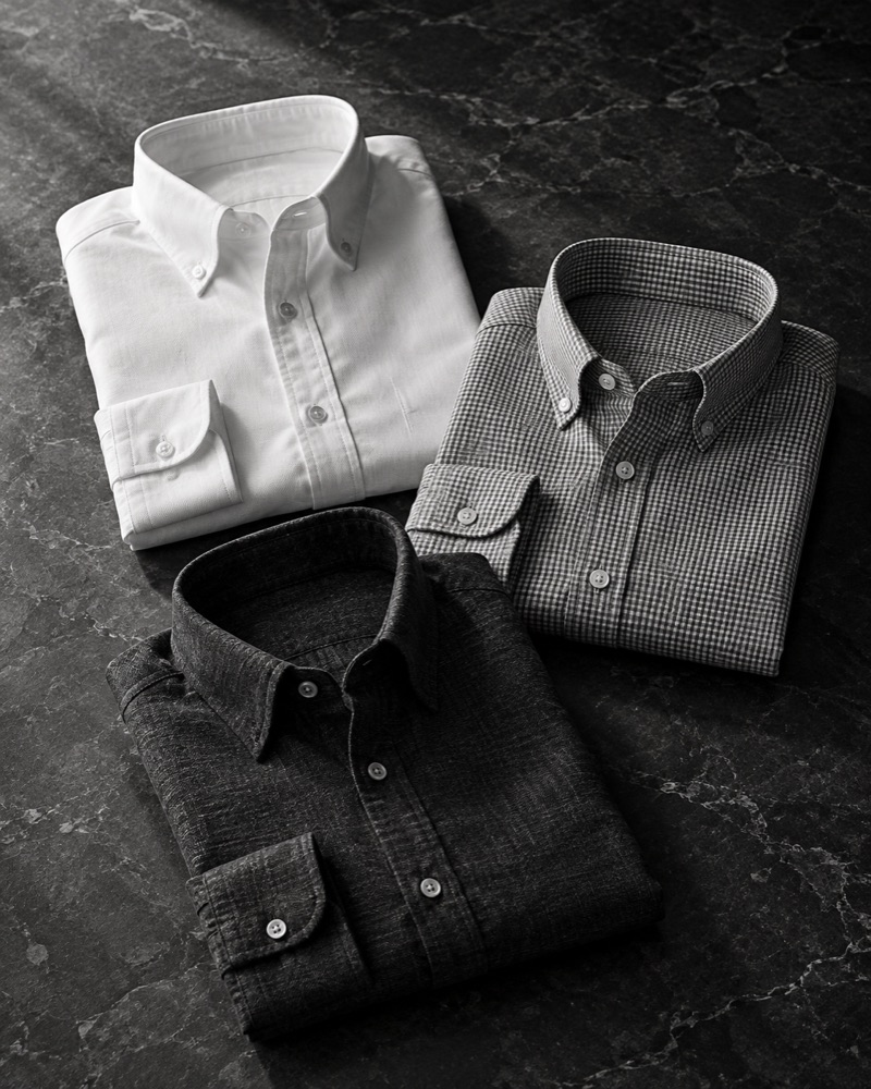 Folded white, patterned, and dark button-down shirts